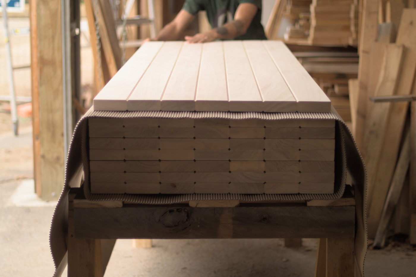 A stack of poplar doors getting wrapped for shipping